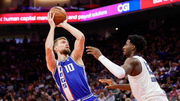 Mar 18, 2024; Sacramento, California, USA; Sacramento Kings forward Domantas Sabonis (10) shoots the ball against Memphis Grizzlies forward Jaren Jackson Jr. (13) during the first quarter at Golden 1 Center. Mandatory Credit: Sergio Estrada-USA TODAY Sports